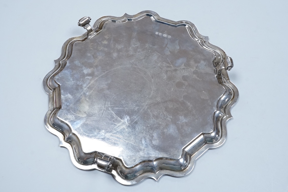 A George V silver salver, by Thomas Bradbury & Sons, of shaped circular form with reeded border and engraved initial, on three scroll feet, Sheffield, 1930, diameter 30.5cm, 33.1oz.